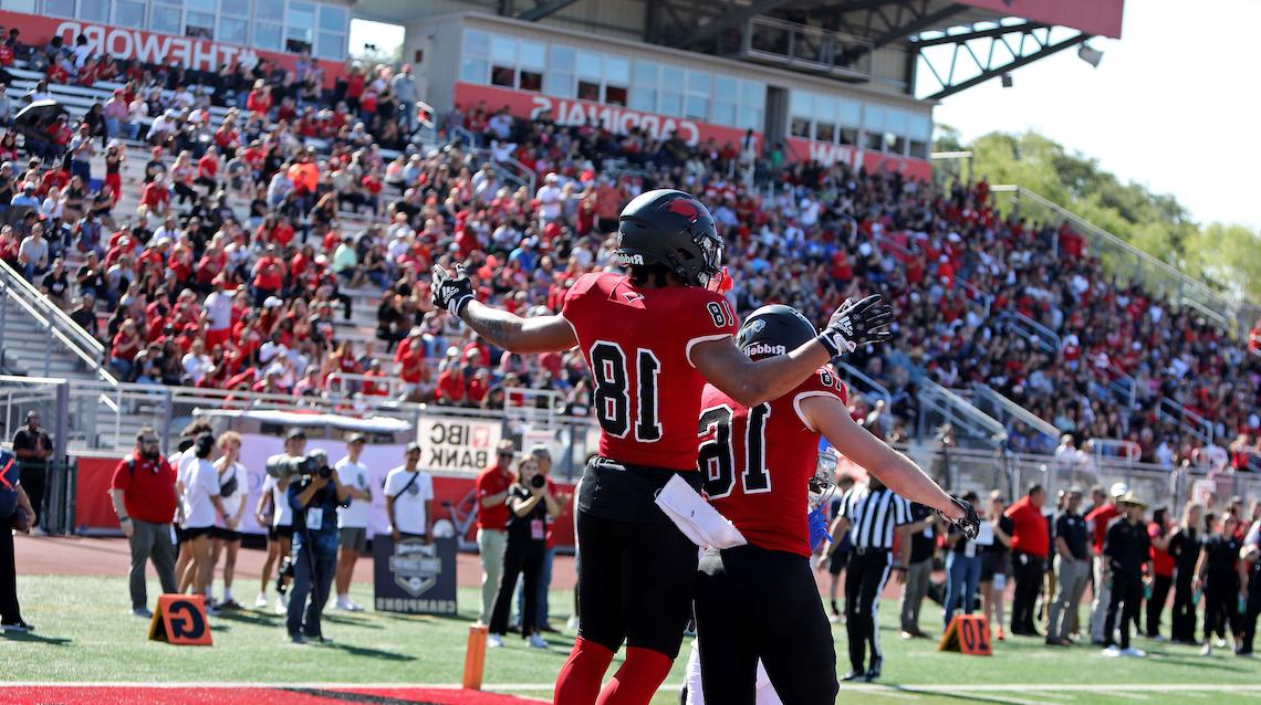 Two UIW football players celebrate at Benson Stadium